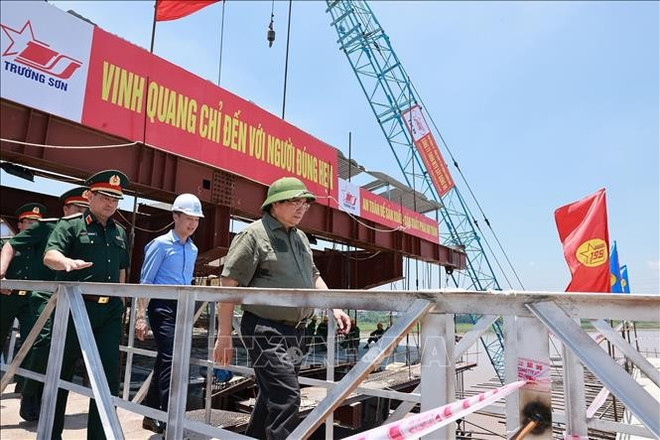 Le Premier ministre Pham Minh Chinh inspecte l'avancement des travaux de construction du nouveau pont de Phong Châu. Photo: VNA phong-chau.jpg
