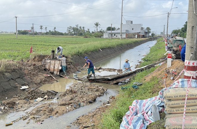 Des ouvriers s’emploient à réparer les sections endommagées du canal Chinh Nam à la suite des pluies et des inondations. Photo: VNA chinh-nam.jpg