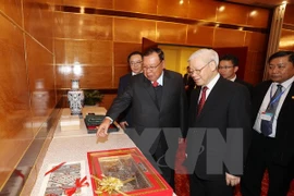 Nguyen Phu Trong et Bounnhang Vorachith à une exposition sur les relations Vietnam-Laos