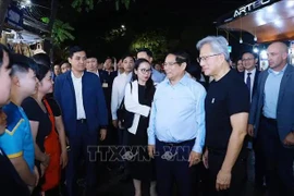 Le Premier ministre vietnamien Pham Minh Chinh (2e de droite à gauche) et le président-directeur général de NVIDIA Jensen Huang (droite) rencontre des habitants de Hanoï jeudi soir. Photo: VNA