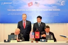'ambassadeur des États-Unis au Vietnam, Ted Osius, et le vice-ministre vietnamien des Transports et des Communications, Nguyên Ngoc Dông, lors de la cérémonie de signature. Photo: NDEL. 