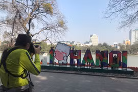 Des touristes au lac de Hoan Kiem (Epée restituée). Photo : daidoanket