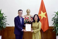 La vice-ministre des Affaires étrangères Lê Thi Thu Hang remet la licence à Kim Kwan Woong, chef du bureau et correspondant résident de Financial News au Vietnam. Photo: ministère des Affaires étrangères 
