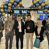 Un représentant de Vietnam Airlines en Indonésie (troisième à partir de la gauche) avec des passagers à l'aéroport international Soekarno-Hatta, en Indonésie. Photo : VNA