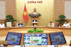 Le Premier minsitre Pham Minh Chinh préside la réunion gouvernementale mensuelle de juin 2025 ainsi qu'une visioconférence nationale entre le gouvernement et les localités. Photo: VNA
