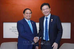 Le Premier ministre Pham Minh Chinh (gauche) rencontre son homologue singapourien Lawrence Wong. Photo: VNA