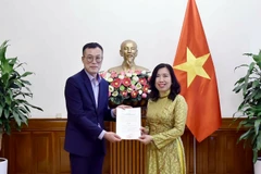 La vice-ministre des Affaires étrangères Lê Thi Thu Hang remet la licence à Kim Kwan Woong, chef du bureau et correspondant résident de Financial News au Vietnam. Photo: ministère des Affaires étrangères 