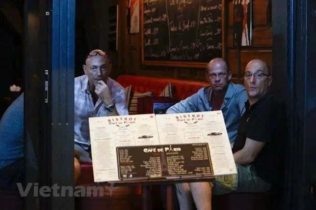 Des touristes étrangers à un stand de bière dans le vieux quartier de Hanoï. (Photo : VietnamPlus) biahoi-938.jpg.webp