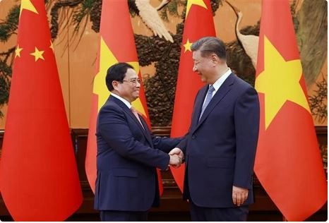 Le Premier ministre Pham Minh Chinh (à gauche) et le secrétaire général et président chinois, Xi Jinping se serrent la main. Photo: VNA xi jinping.JPG