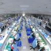 Chaîne de production électronique au sein de la société Suntech. Photo: VNA