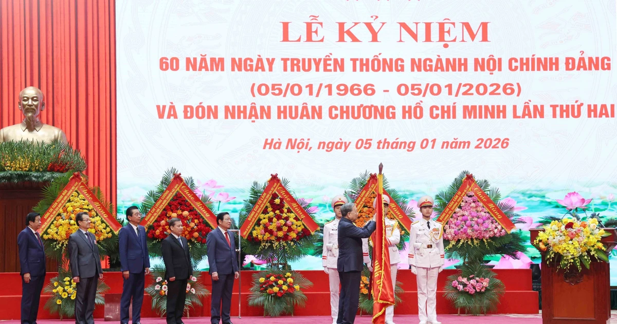 Le secrétaire général Tô Lâm attache l’Ordre Hô Chi Minh sur le drapeau traditionnel de la Commission des affaires intérieures du Comité central du Parti. Photo : VNA