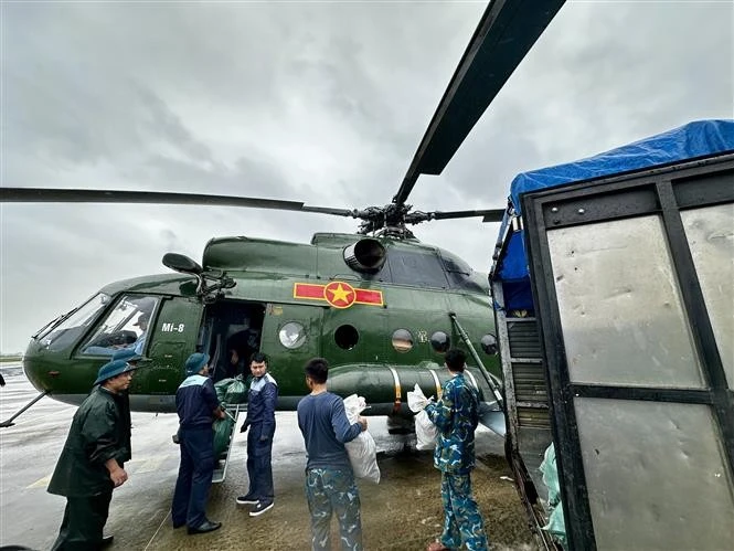 Des vivres sont chargés à bord d'un hélicoptère pour venir en aide aux populations isolées par les inondations au Centre. Photo : VNA.