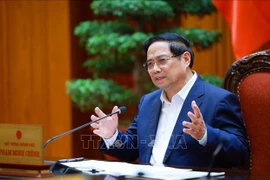 Le Premier ministre Pham Minh Chinh s'exprime lors de la réunion, à Hanoi, le 24 décembre. Photo: VNA