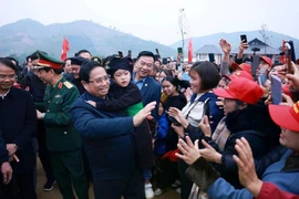 Le Premier ministre Pham Minh Chinh (deuxième à partir de la gauche) rencontre les gens du village de Nu. Photo : VNA