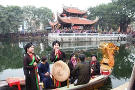 Les artistes, en groupes d'hommes et de femmes, présentent le quan ho (chant alterné). Photo : VietnamPlus