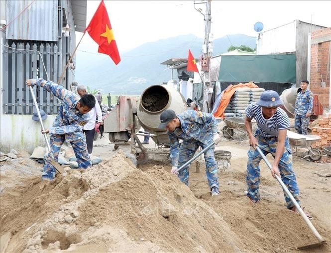 70 soldats sont mobilisés simultanément sur les quatre bâtisses afin de reconstruire les habitations détruites par les inondations. Photo: VNA