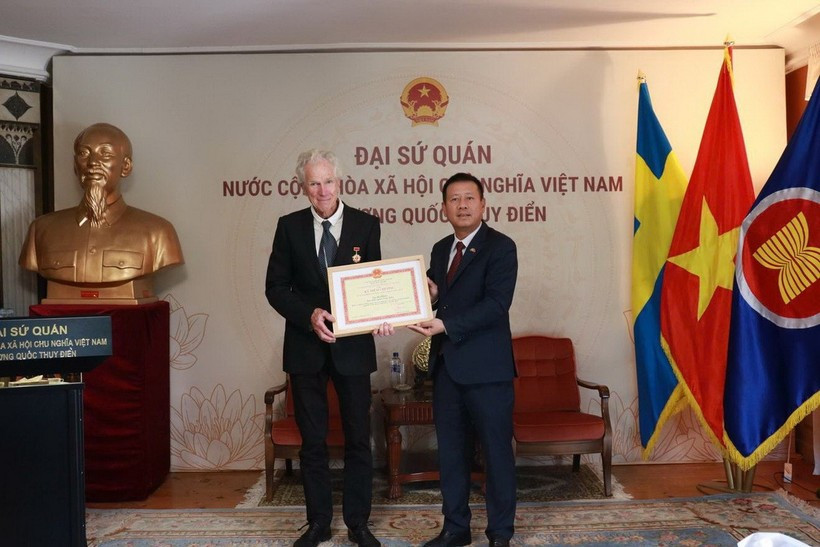 L’ambassadeur du Vietnam en Suède, Trân Van Tuân (droite), remet l’insigne « Pour la cause de la Culture, des Sports et du Tourisme » au réalisateur suédois Bo Öhlén. Photo: VNA