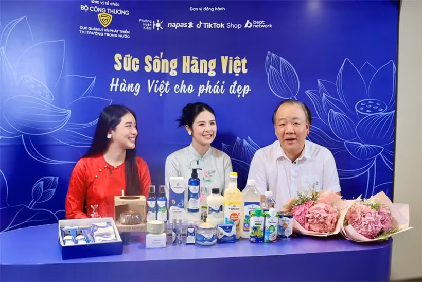 Tran Huu Linh, directeur de l'Agence pour la surveillance et le développement du marché intérieur, et deux personnalités lors de livestream "Vitalité des produits vietnamiens". Photo: qdnd.vn