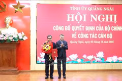 Le Minh Hung, membre du Bureau politique, secrétaire du Comité central du Parti et président de sa Commission d'organisation (droite) félicite Ho Van Nien. Photo ; VNA