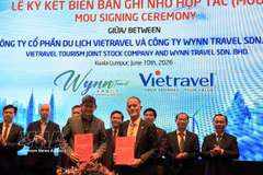 Des entreprises de voyage vietnamiennes et malaisiennes signent un accord de coopération lors de la conférence. Photo : VNA 