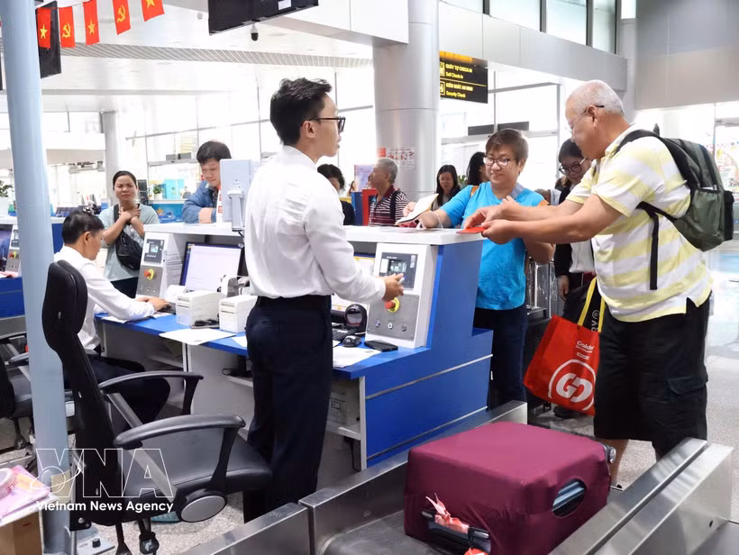 Des touristes internationaux effectuent les formalités d’enregistrement à l’aéroport international de Lien Khuong. Photo : VNA