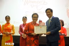 L'ambassadeur du Vietnam en Malaisie, Dinh Ngoc Linh, remis un certificat de mérite à Mme Tran Thi Chang, présidente de l'Association d'amitié Malaisie-Vietnam, lors de la célébration. Photo : VNA