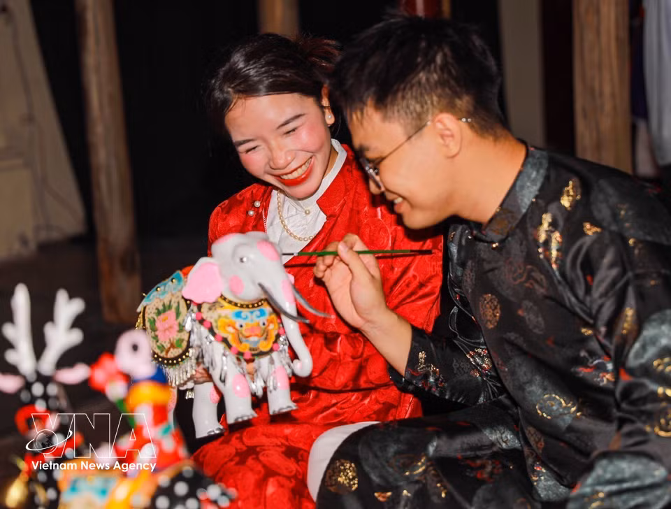 Des visiteurs découvrent avec plaisir les jouets traditionnels de la Fête de la Mi-Automne. Photo: VNA