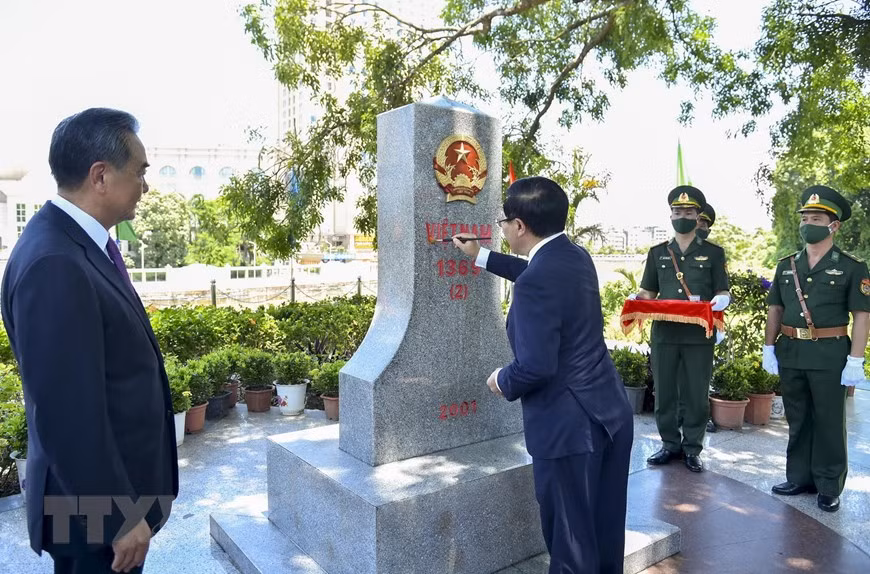  Le vice-Premier ministre et ministre des Affaires étrangères, Pham Binh Minh, repeint la borne frontalière 1369, en présence du conseiller d’Etat et ministre chinois des Affaires étrangères, Wang Yi. 