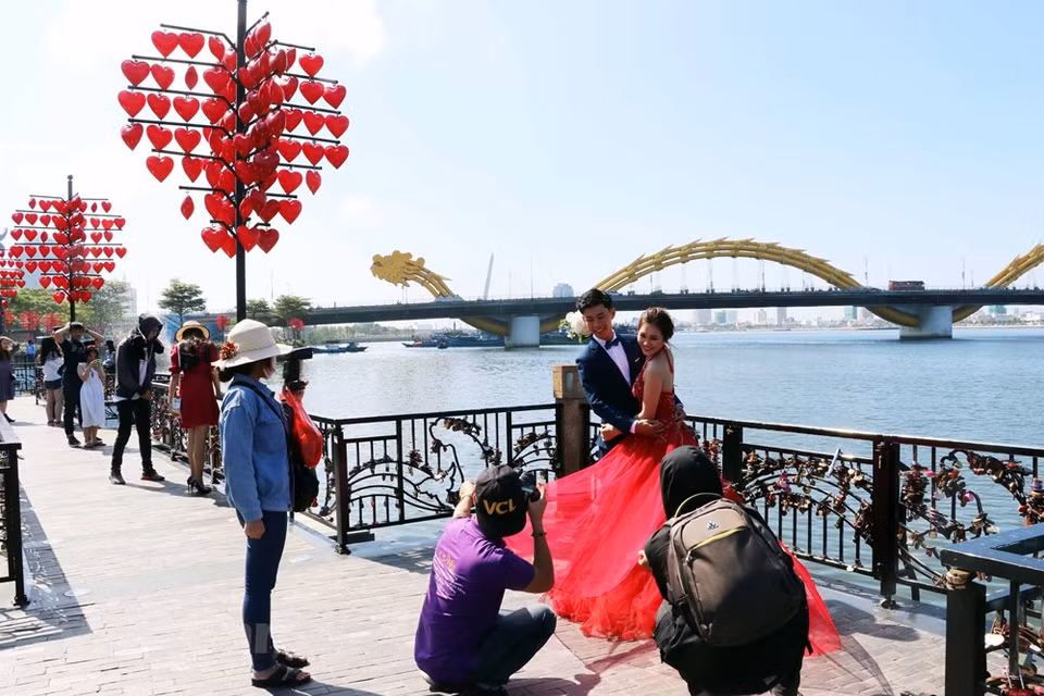 Un couple prend les photos de mariage sur le pont. 