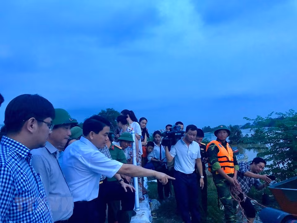 Le président du comité populaire de Hanoï, Nguyen Duc Chung (3e de gauche) est venu examiner les travaux de renforcement de digues dans le district de Chuong My