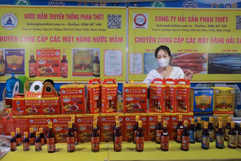 Des bouteilles de «nuoc mam» de Phan Thiet sont présentées lors de la Semaine. Comme le riz, le «nuoc mam » est un condiment de base de presque tous les plats au Vietnam. «Pour les Vietnamiens, un repas sans nuoc mam est considéré comme incomplet», a écrit le Professeur Trân Ngoc Thêm dans son livre Les fondements de la culture vietnamienne. Un bol de nuoc mam (sauce de poisson) est toujours placé au centre de la table afin que chacun puisse l’atteindre. Certains peuvent ne pas manger de légumes, d’autres de viande, mais tout le monde consomme du riz et du «nuoc mam». On dit que le «nuoc mam» permet de distinguer la nourriture vietnamienne de celle de ses voisins.