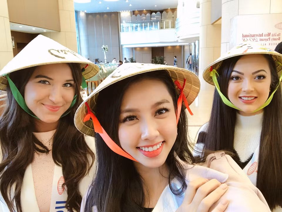 La représentante vietnamienne au concours de beauté Miss International 2018, Nguyen Thuc Thuy Tien (centre), a offert des chapeaux coniques aux candidates de ce concours.